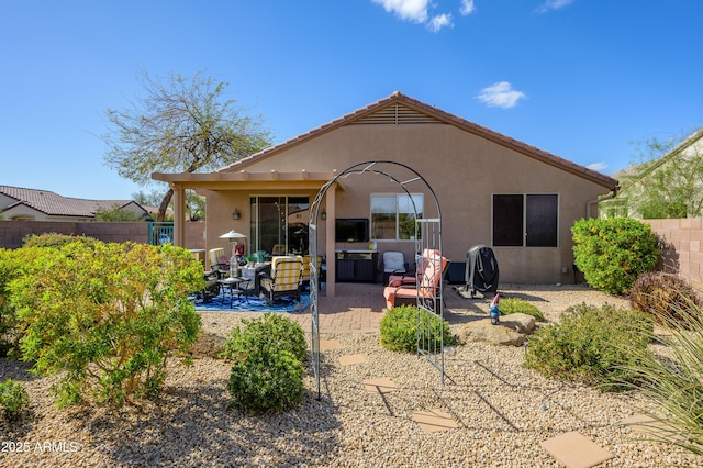 back of house with a patio area, fence, and stucco siding