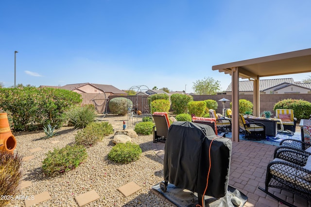 view of patio featuring a fenced backyard and a grill