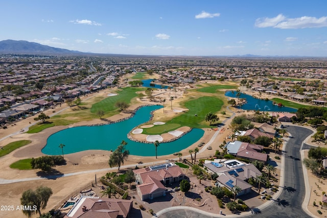 aerial view with view of golf course, a water view, and a residential view