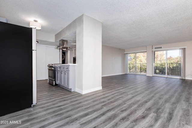 425 Paseo Redondo Unit 6L, Tucson, AZ 85701 - unfurnished living room featuring a textured ceiling and wood finished floors