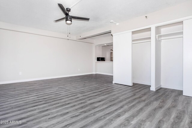 425 Paseo Redondo Unit 6L, Tucson, AZ 85701 - unfurnished bedroom featuring wood finished floors and two closets