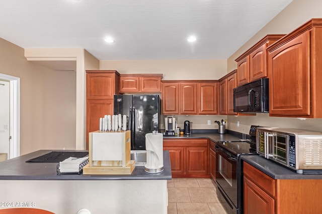 kitchen with black appliances and light tile patterned floors