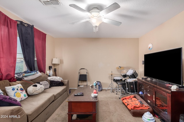 living room featuring light carpet and ceiling fan