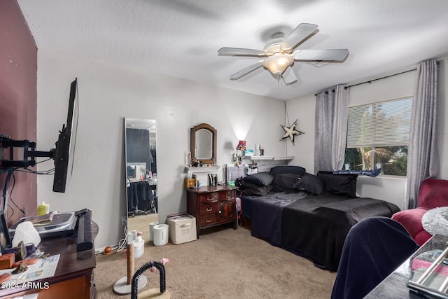 carpeted bedroom with a textured ceiling and ceiling fan