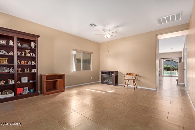 unfurnished room featuring light tile patterned floors and ceiling fan