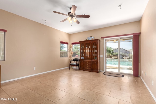 tiled empty room with ceiling fan