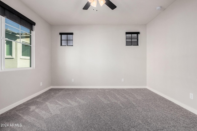 empty room featuring carpet flooring and ceiling fan