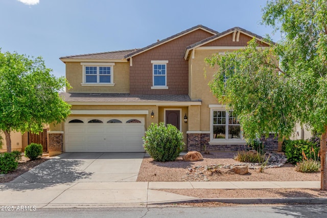 4125 W Lydia Ln, Phoenix, AZ 85041 - craftsman-style home featuring stone siding, a garage, concrete driveway, and stucco siding
