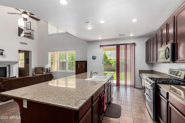 4125 W Lydia Ln, Phoenix, AZ 85041 - kitchen with an island with sink, a sink, open floor plan, stainless steel appliances, and visible vents