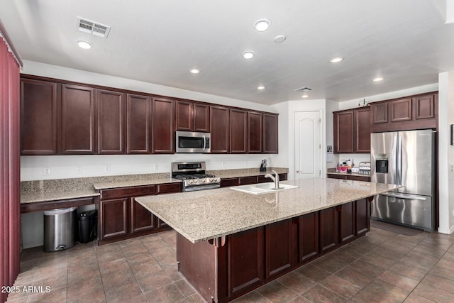 4125 W Lydia Ln, Phoenix, AZ 85041 - kitchen featuring an island with sink, a sink, stainless steel appliances, visible vents, and recessed lighting