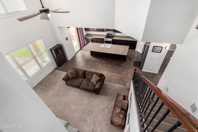 4125 W Lydia Ln, Phoenix, AZ 85041 - living room with a high ceiling, a ceiling fan, and stairway