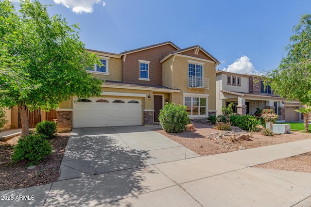 4125 W Lydia Ln, Phoenix, AZ 85041 - view of front of home featuring stone siding, stucco siding, concrete driveway, and a garage