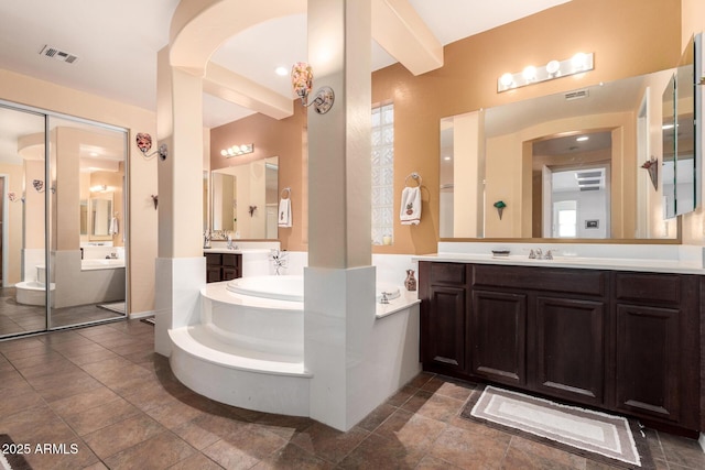 4125 W Lydia Ln, Phoenix, AZ 85041 - full bath with a sink, a bath, two vanities, and visible vents