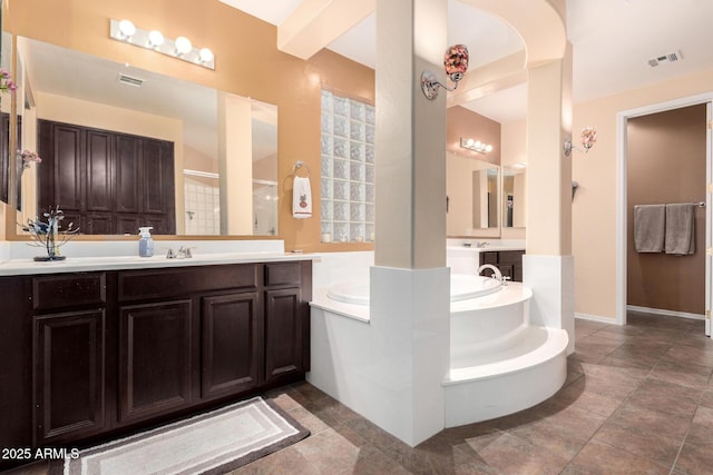 4125 W Lydia Ln, Phoenix, AZ 85041 - full bathroom with a shower stall, a sink, a garden tub, visible vents, and two vanities