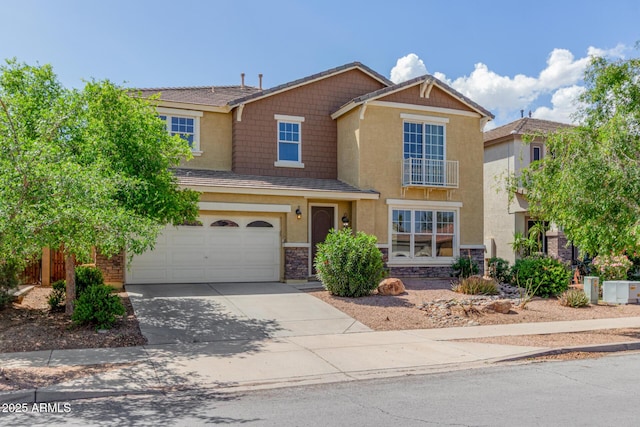 4125 W Lydia Ln, Phoenix, AZ 85041 - view of front of property featuring driveway, stucco siding, an attached garage, and stone siding
