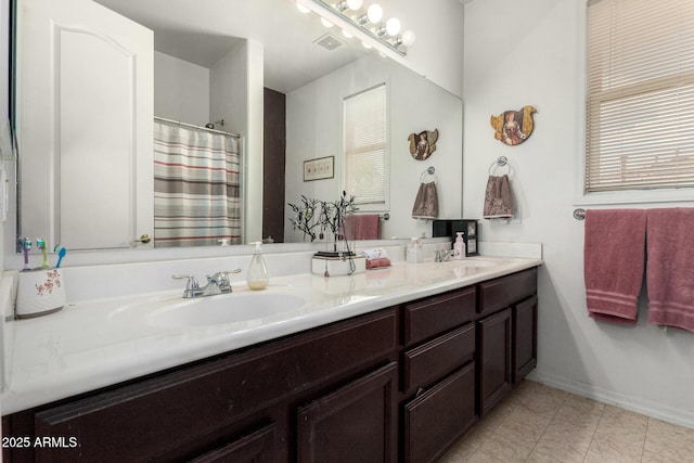4125 W Lydia Ln, Phoenix, AZ 85041 - bathroom with double vanity, a sink, curtained shower, and baseboards