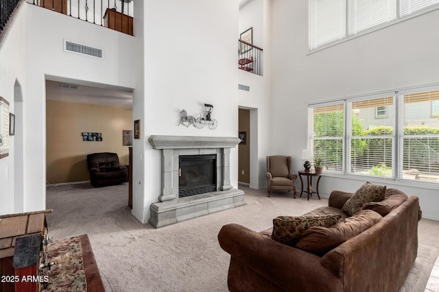 4125 W Lydia Ln, Phoenix, AZ 85041 - carpeted living room featuring baseboards, visible vents, and a tiled fireplace