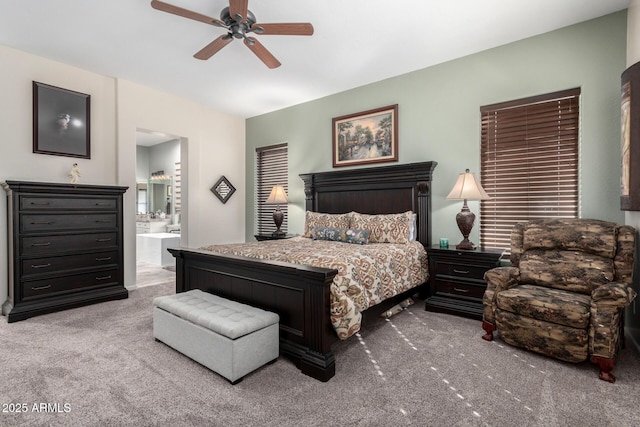 bedroom with carpet, connected bathroom, and ceiling fan