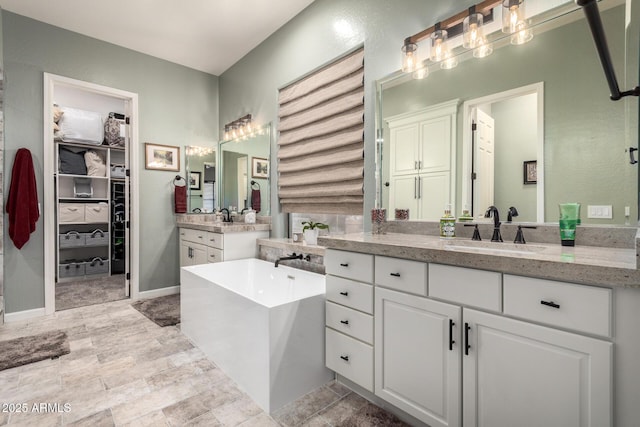 bathroom featuring vanity and a tub