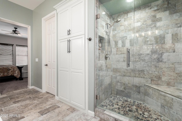 bathroom with a shower with door and ceiling fan