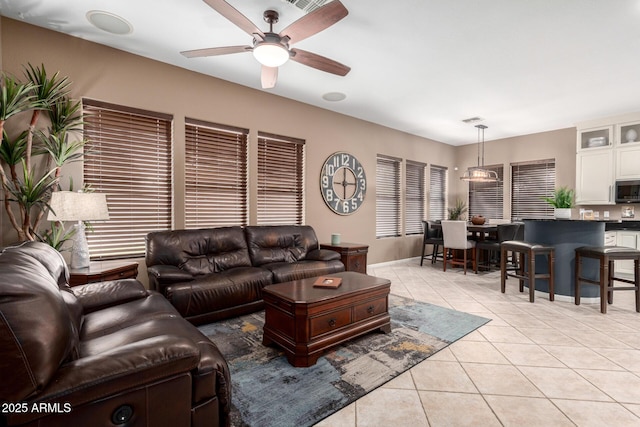 tiled living room with ceiling fan