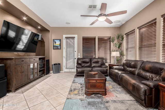 tiled living room featuring ceiling fan