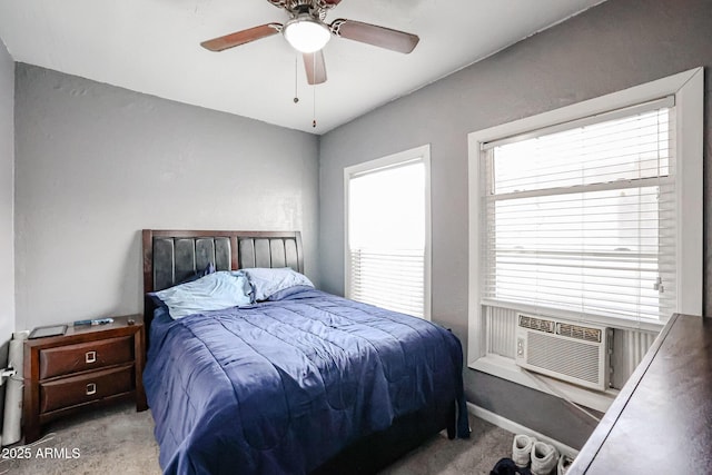 carpeted bedroom with multiple windows, ceiling fan, and cooling unit