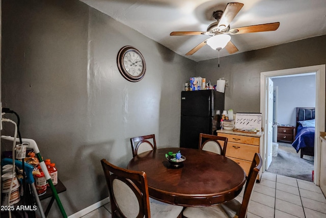 dining space with ceiling fan and light tile patterned flooring