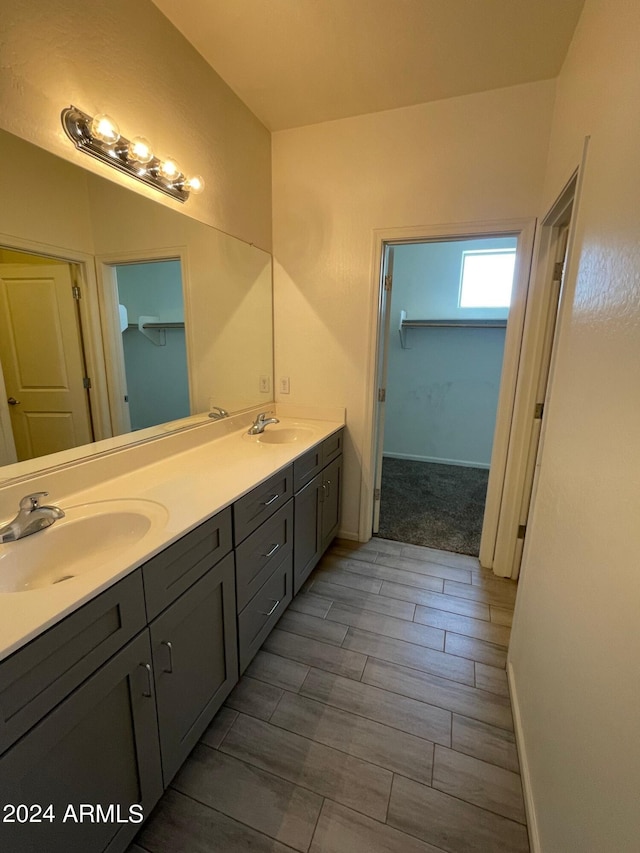 bathroom featuring dual vanity