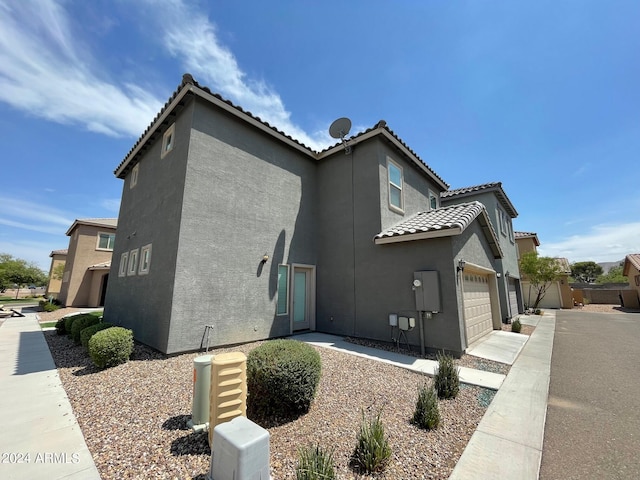 view of side of home featuring a garage