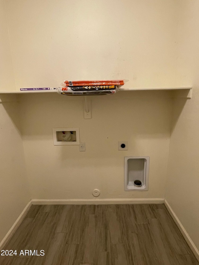 clothes washing area with hardwood / wood-style floors, hookup for a gas dryer, hookup for an electric dryer, and washer hookup