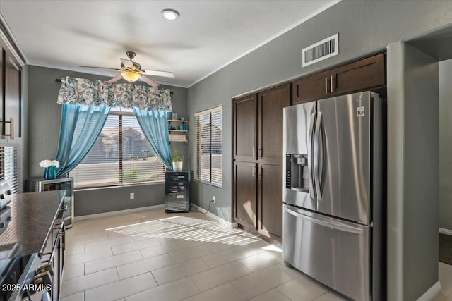 kitchen with visible vents, a ceiling fan, dark brown cabinets, ornamental molding, and stainless steel refrigerator with ice dispenser