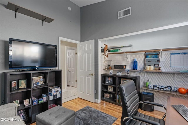 office area with visible vents and wood finished floors