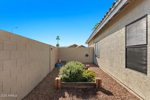 view of yard featuring a garden and a fenced backyard