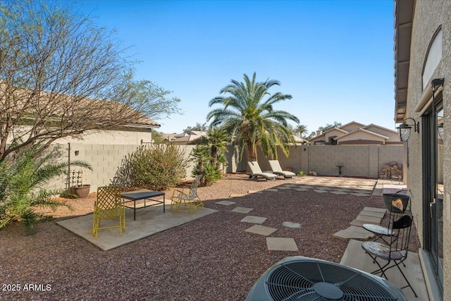 view of yard featuring central AC, a patio, and a fenced backyard