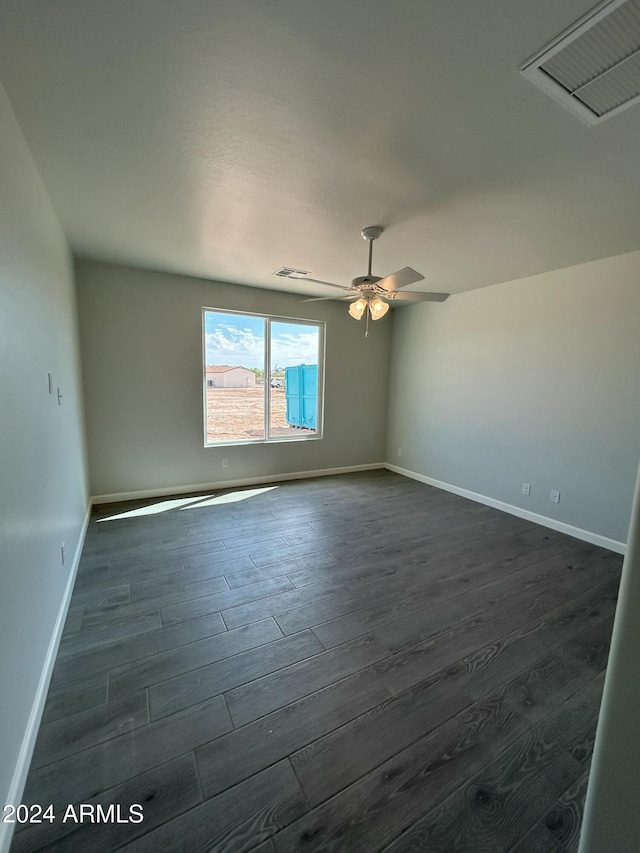 spare room featuring dark hardwood / wood-style floors and ceiling fan