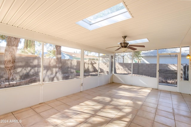 unfurnished sunroom featuring a skylight, ceiling fan, and wood ceiling