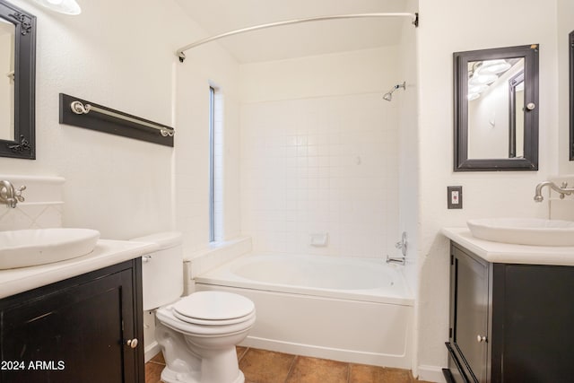 full bathroom featuring tiled shower / bath, vanity, a healthy amount of sunlight, and toilet