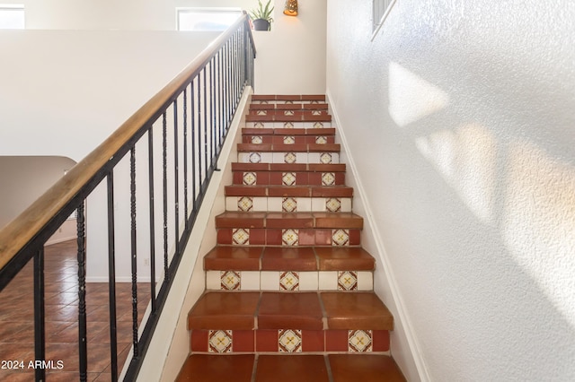 staircase featuring tile patterned floors