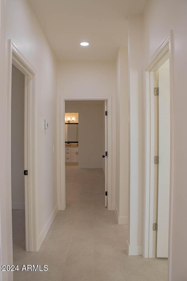 hall featuring light tile patterned flooring