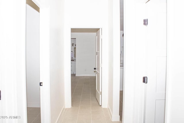 corridor with light tile patterned flooring