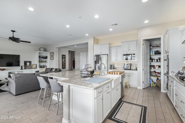 kitchen featuring appliances with stainless steel finishes, visible vents, and white cabinetry