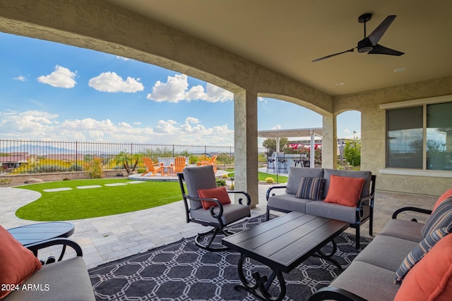 view of patio featuring a fenced backyard, an outdoor hangout area, a ceiling fan, and outdoor dining space