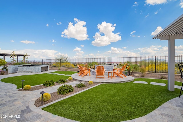 view of yard with an outdoor fire pit, a fenced backyard, and a patio