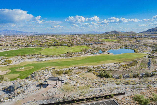 drone / aerial view with view of golf course and a mountain view