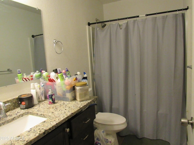 bathroom with toilet, curtained shower, and vanity