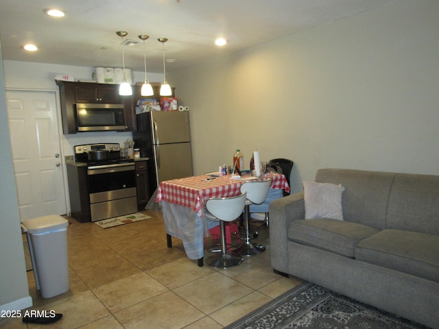 living area with recessed lighting and light tile patterned floors