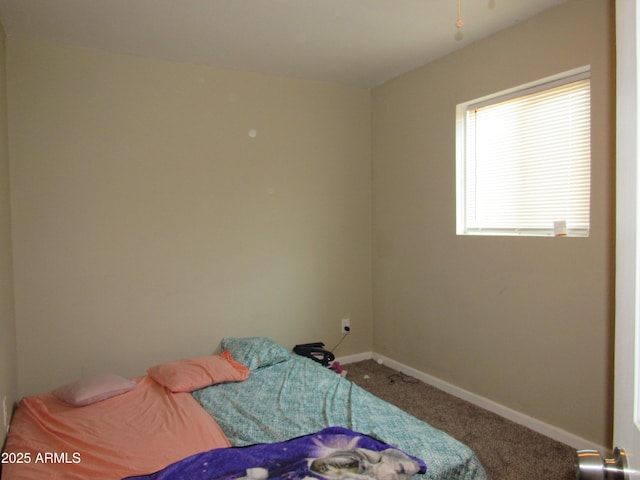 bedroom with carpet floors and baseboards