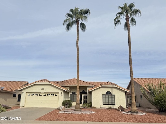 mediterranean / spanish-style home featuring a garage