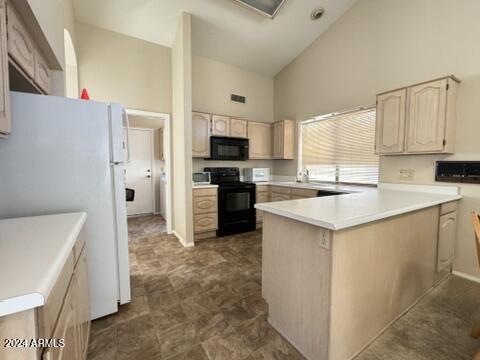 kitchen with kitchen peninsula, light brown cabinetry, high vaulted ceiling, and black appliances